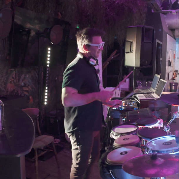 DJ performing live percussion while mixing music at a private party at The Ugly Duckling in Bowdon, Altrincham.