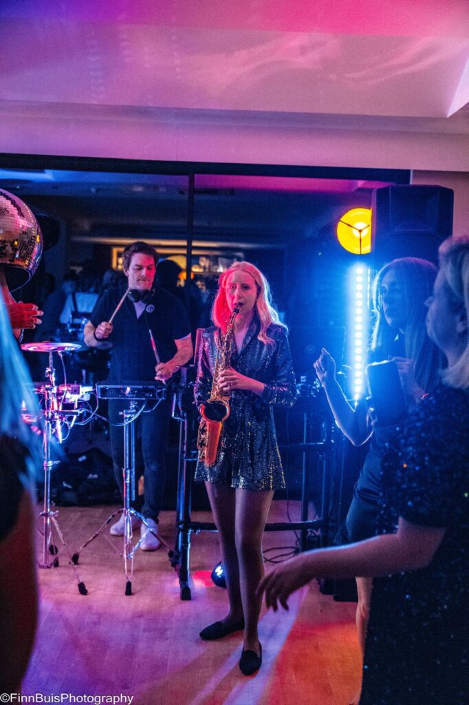 Live saxophonist and percussionist performing with DJ at Windlesham Golf Club party Surrey